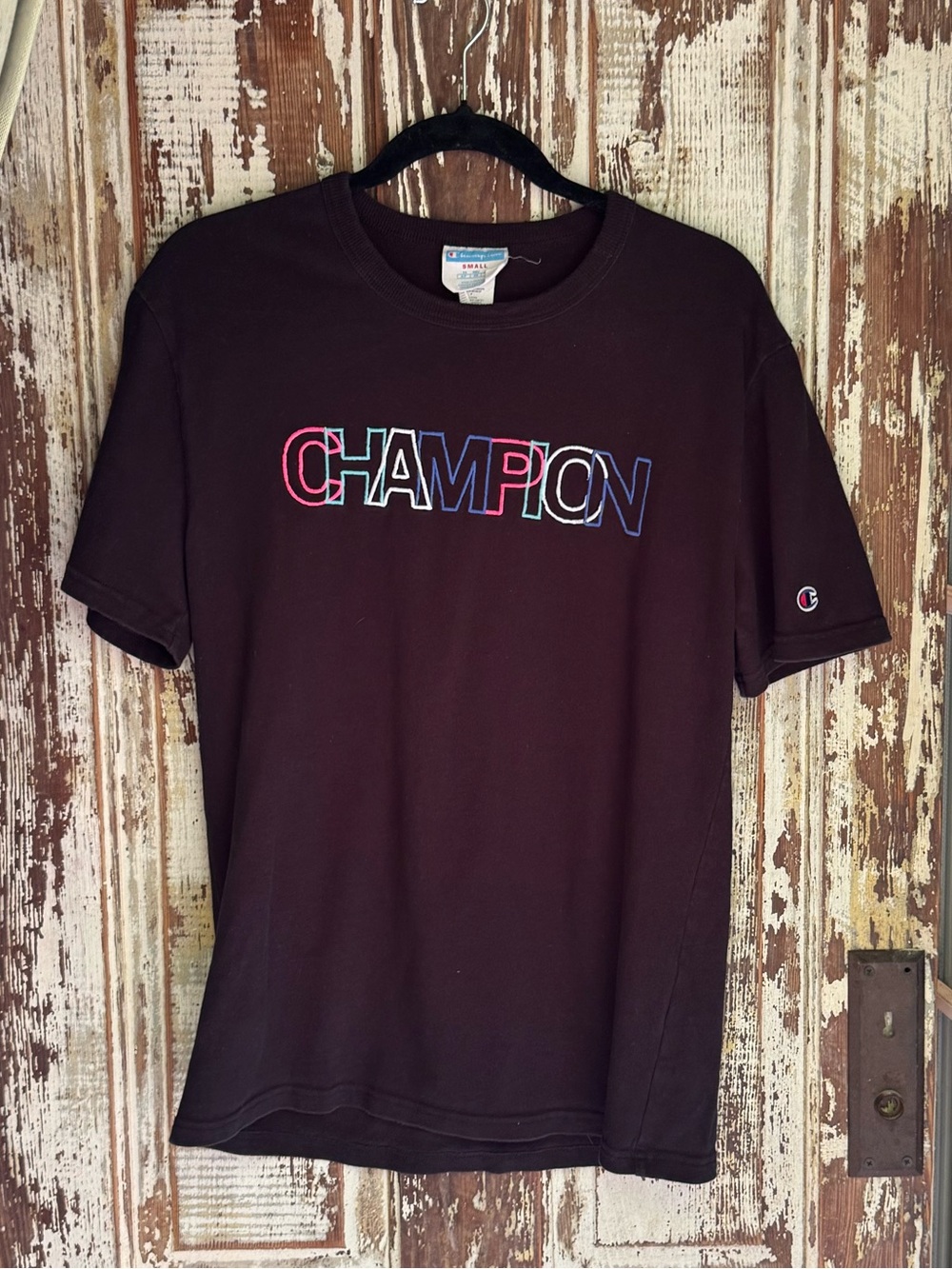 Vintage Champion Black Short Sleeve Crewneck Tee with Multicolor Logo.